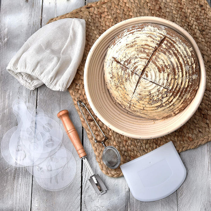 proofing basket for bread on brown table mat with bread stencils wooden lame mini sifter plastic bowl scraper 